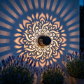 Mandala doré projeté sur un mur de pierre au crépuscule